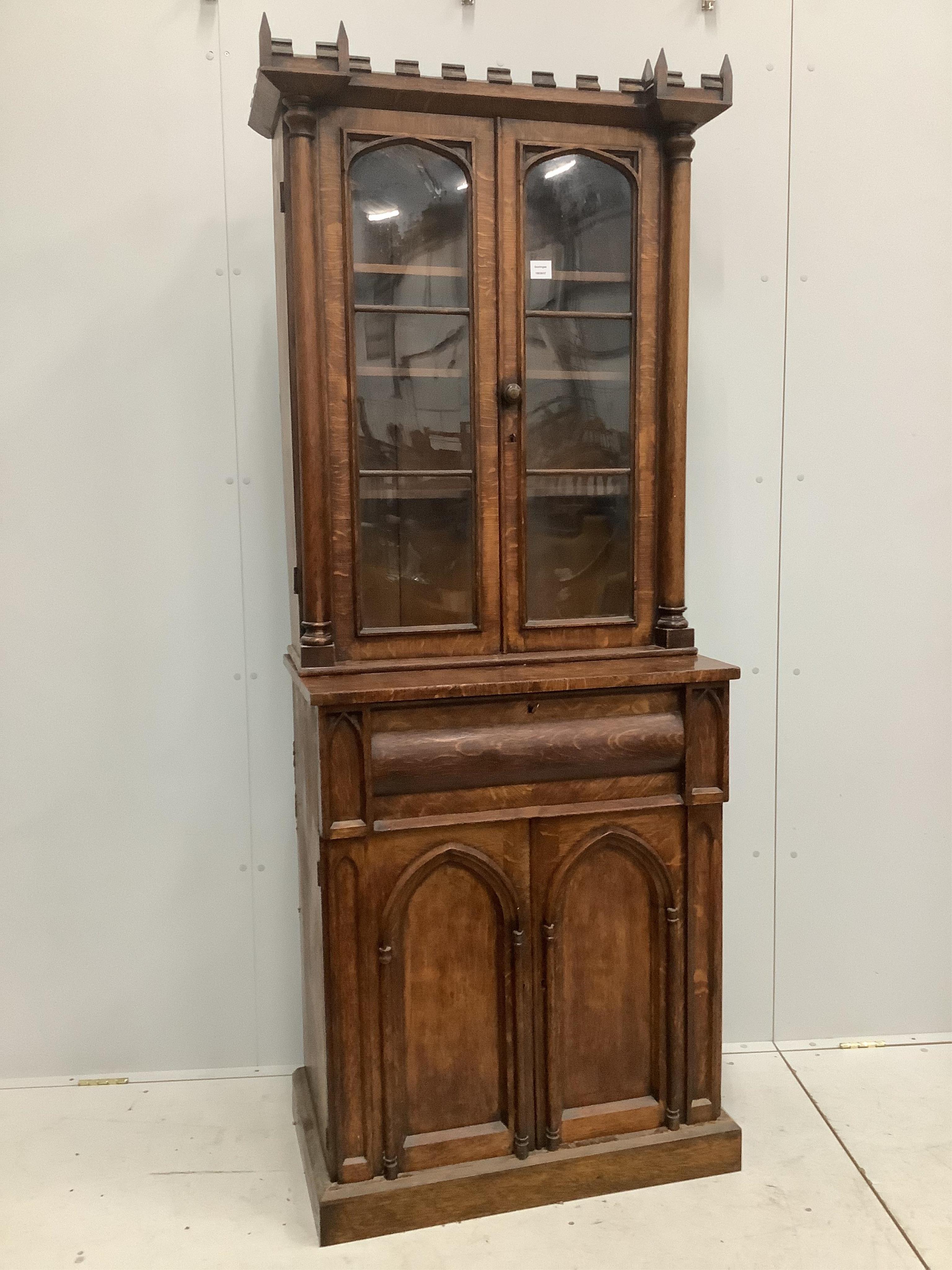 A William IV Gothic Revival oak secretaire bookcase, width 85cm, depth 47cm, height 209cm. Condition - poor to fair